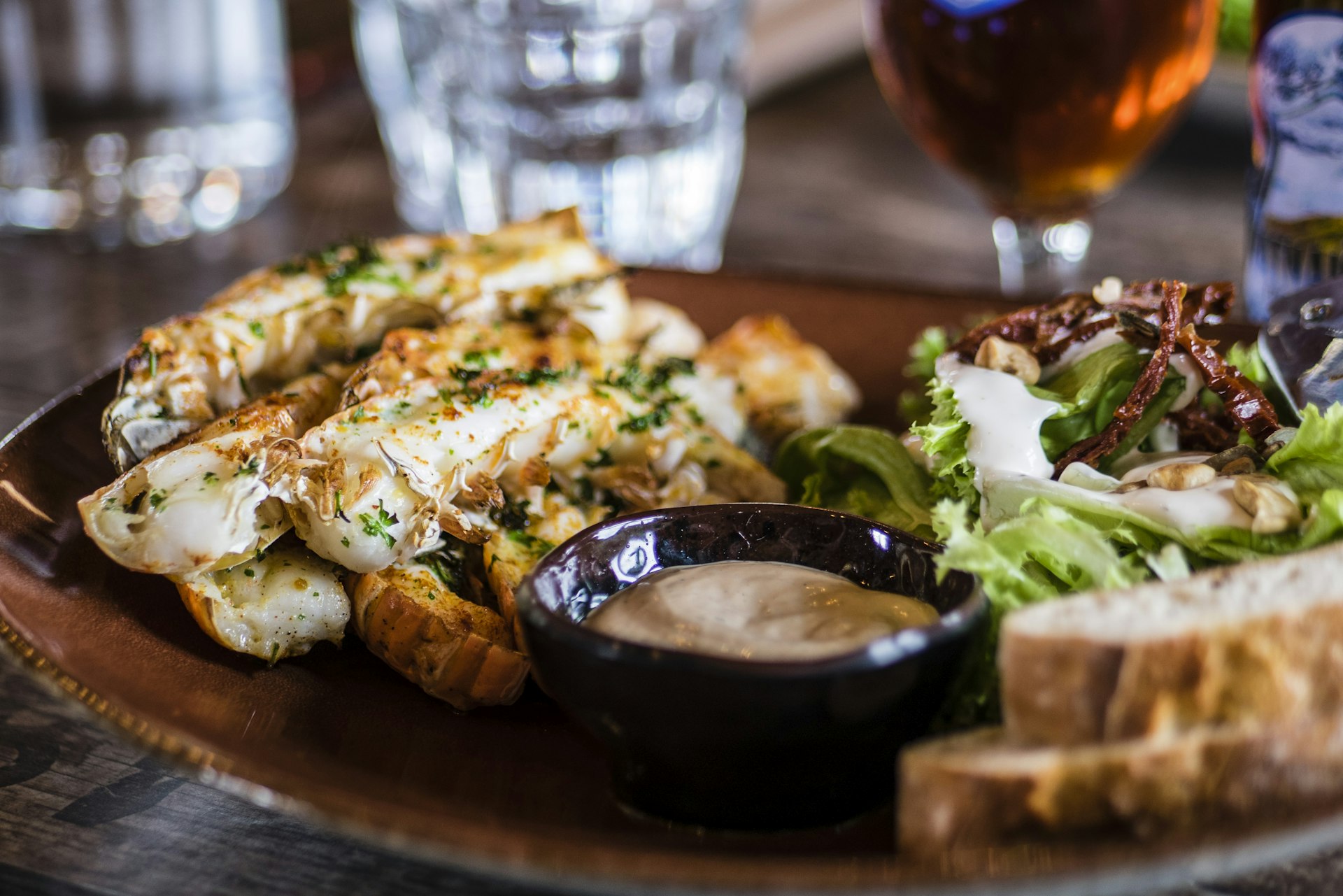 overhead view of elegant modern cuisine served on ceramic plates, rustic wooden table, photorealistic, 8k, bright natural lighting, highly detailed food photography